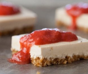 Easy no-bake vegan cheesecake bars with brown rice cereal crust and strawberry topping