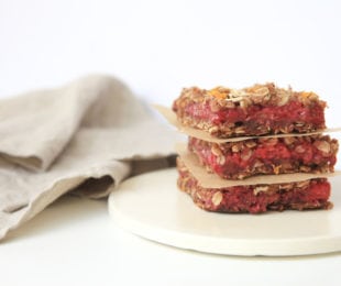 Raspberry orange oat bars stacked on each other